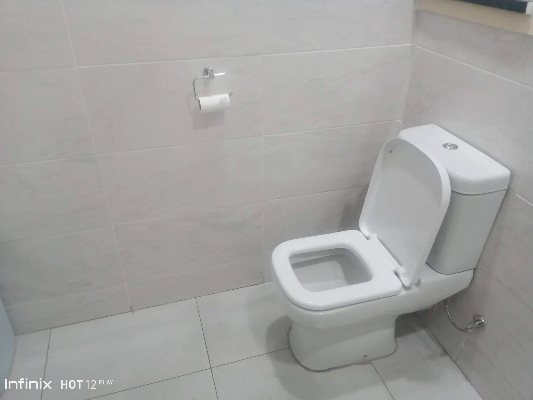 Toilet installation in tiled washroom